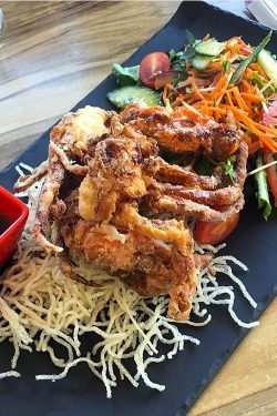 Salt and pepper spiced soft shell crab with mixed salad greens and fried noodles with lime and sweet chilli sauce